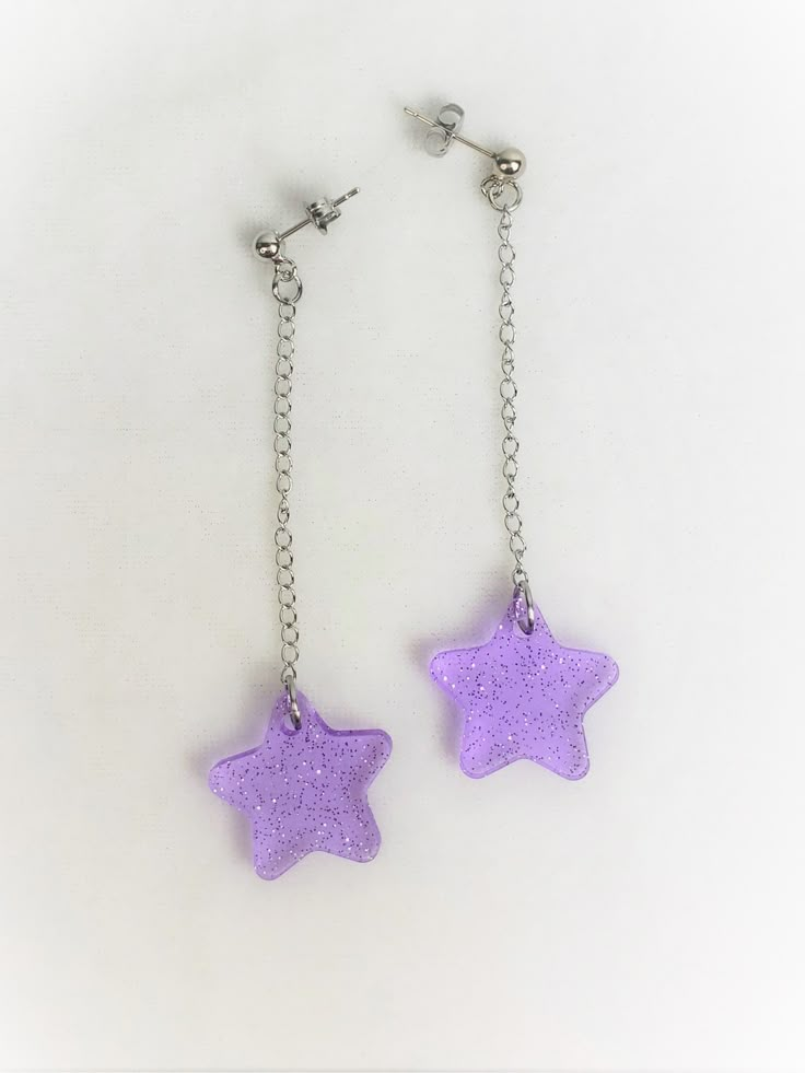 Mini Sparkle Star Dangle Earrings, choose your color! You can also mix and match, just leave me a note when you check out and let me know what colors you would like!Choice of sterling silver .925 or surgical stainless steel(These earrings pictured are made with surgical stainless-steel studs, chain is stainless steel and wont tarnish)Approximately .75" wide, and 3" long from top of metal stud, you can get these made with hooks also.These are super cute and dainty earrings. Originally made with a Cute Purple Dangle Jewelry, Fun Purple Dangle Jewelry, Cute Dangle Earrings With Star Charm, Trendy Purple Star Shaped Jewelry, Pink Dangle Earrings With Star Charm, Purple Star Earrings, Pink Sparkle, Pink Acrylics, Magical Jewelry