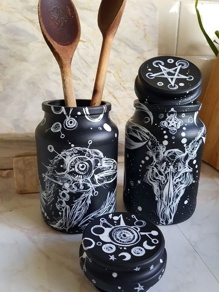 three jars with spoons in them sitting on a counter