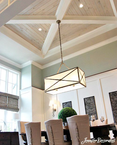 a chandelier hanging from the ceiling in a dining room