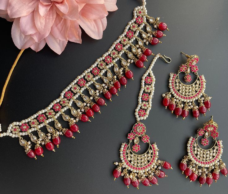 This is a beautiful Choker that comes with a set of earrings and Maangtika. Can be worn on any outfit or for a bridal look as its a complete set. Perfect for Mehendi or Sangeet! Cheap Party Jewelry For Navratri, Festive Red Necklace With Matching Earrings, Festive Red Necklaces With Matching Earrings, Elegant Red Kundan Jewelry Sets, Bollywood Style Red Jewelry With Matching Earrings, Bollywood Style Red Ruby Bridal Earrings, Red Ruby Bollywood Bridal Earrings, Bollywood Style Ruby Red Bridal Earrings, Red Chandbali Jewelry Sets For Diwali