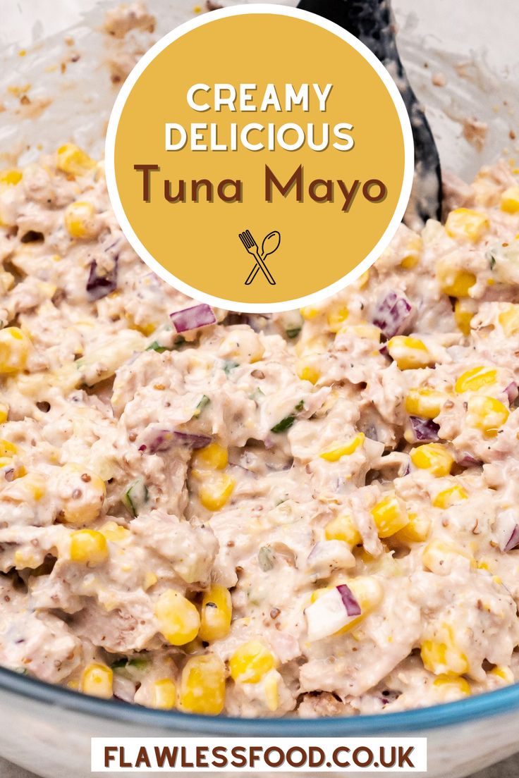 a bowl filled with creamed tuna and corn next to a black spoon in it