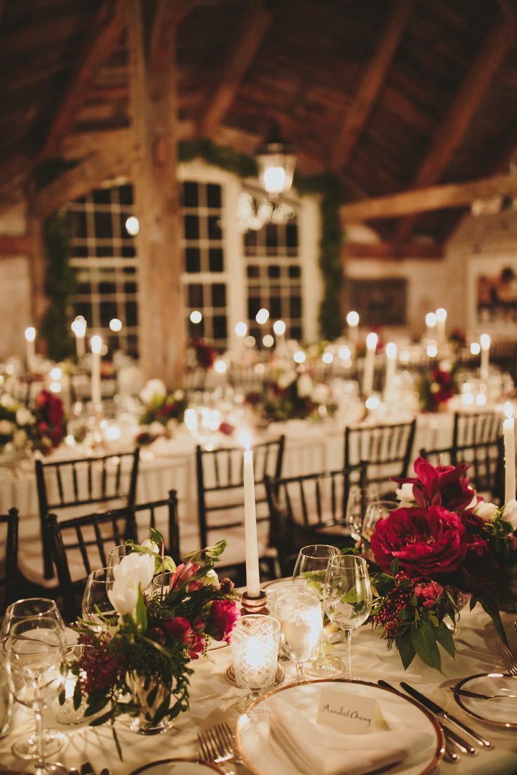 the table is set with candles, plates and napkins for an elegant wedding reception