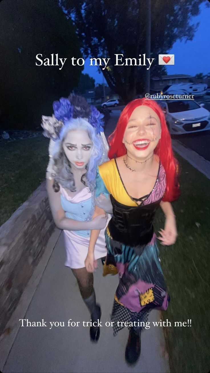 two women dressed as the little mermaids are walking down a sidewalk with their faces painted to look like they're smiling