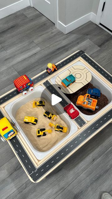 a child's play area with cars and trucks on the floor in front of a door