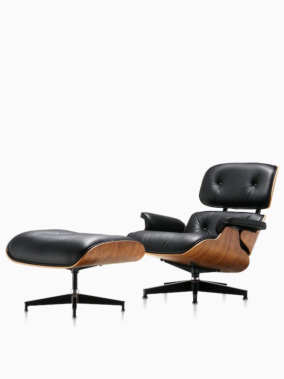 an eames lounge chair and ottoman in black leather