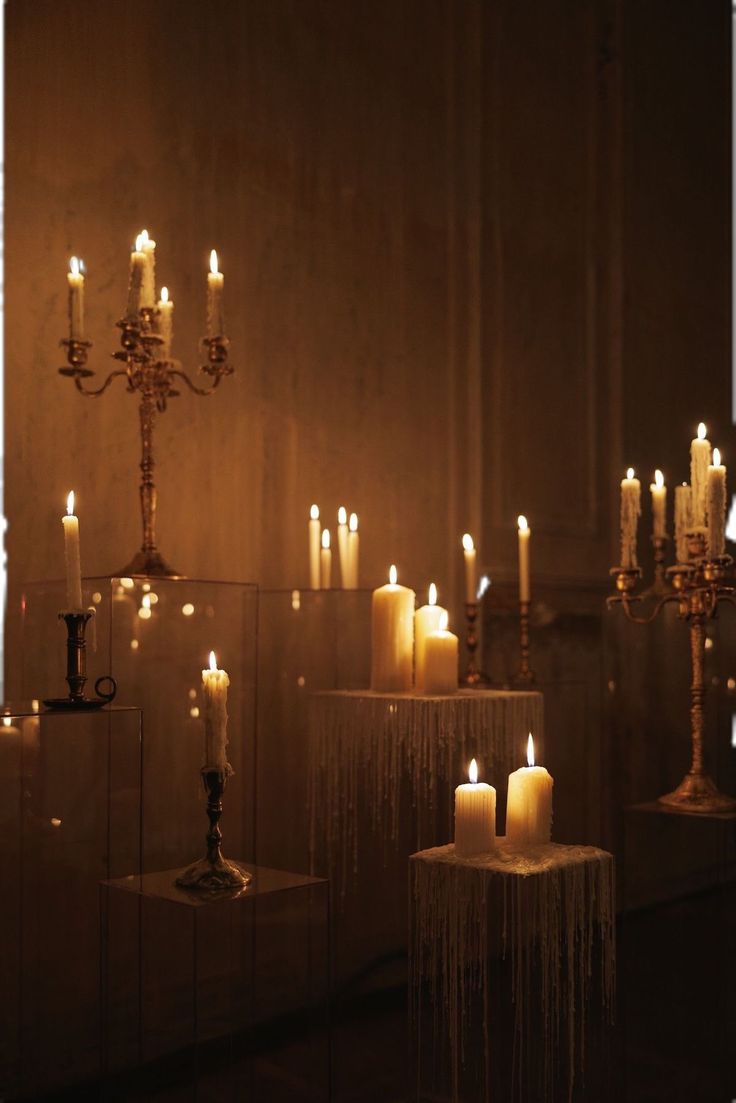 many candles are lit in an old church