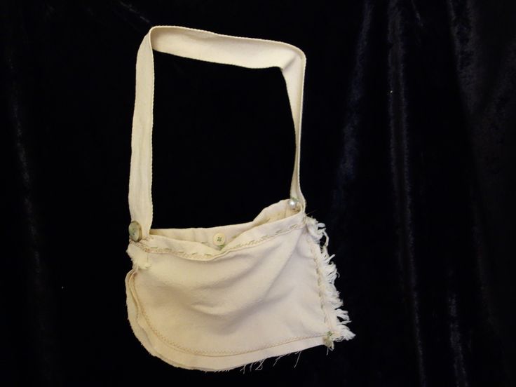 This is a smaller sized purse/handbag that measures 10" x7" (body of purse) with a 20" strap handle-which is 10" drop length. It is made with a 100% cotton muslin type fabric. It also has hand embroidery details in sage green. There are also different kinds of buttons added as accents. There is a button and with a loop in the center to close the purse with.  If you have any questions please feel free to contact me. Thank you for visiting my shop. Eco-friendly Cotton Canvas Bag With Removable Pouch, Beige Cotton Shoulder Bag With Removable Pouch, Cotton Crossbody Bag With Removable Pouch, Beige Rectangular Cotton Satchel, White Cotton Canvas Bag With Removable Pouch, Cotton Canvas Pouch Bag For Everyday Use, Everyday Cotton Canvas Pouch Bag, White Cotton Crochet Shoulder Bag, White Crochet Cotton Shoulder Bag