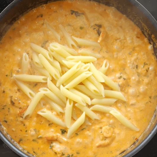 some pasta is being cooked in a pot