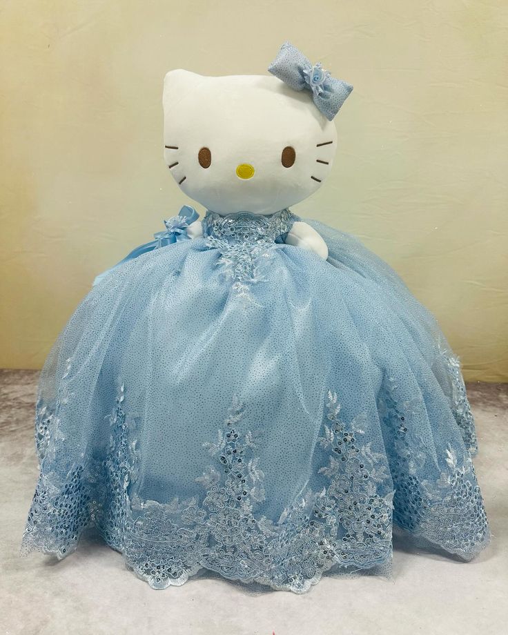 a hello kitty stuffed animal in a blue dress