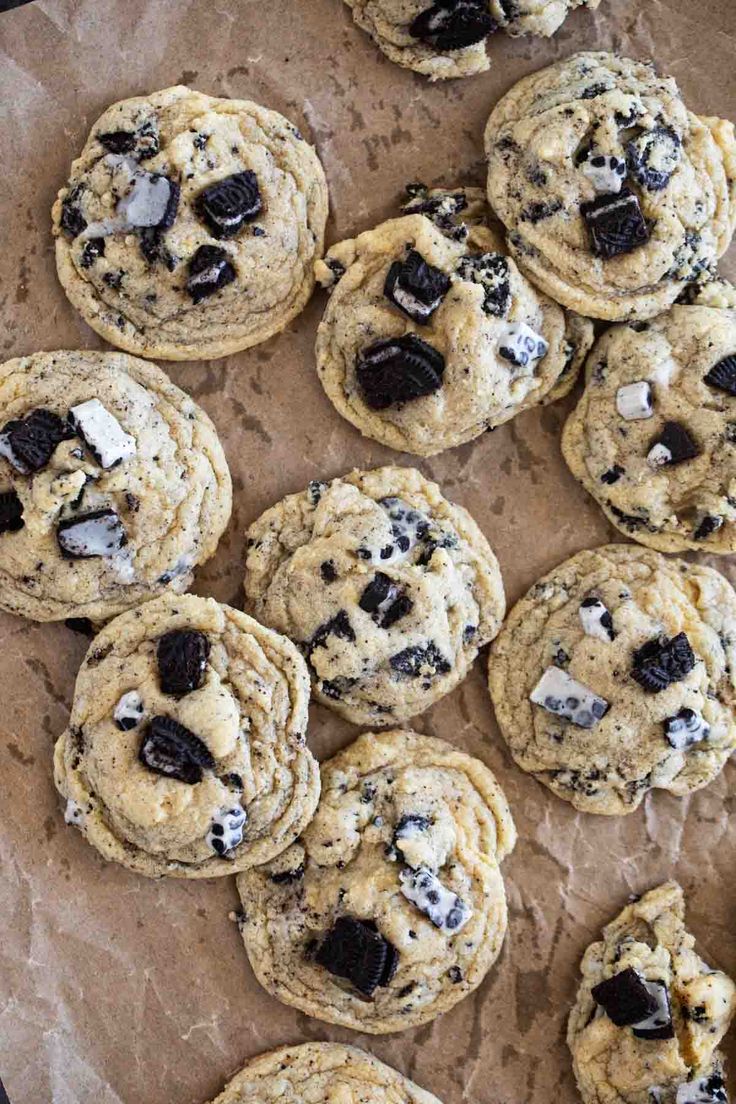 chocolate chip cookies are arranged on a piece of parchment paper