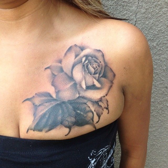 a woman with a rose tattoo on her chest