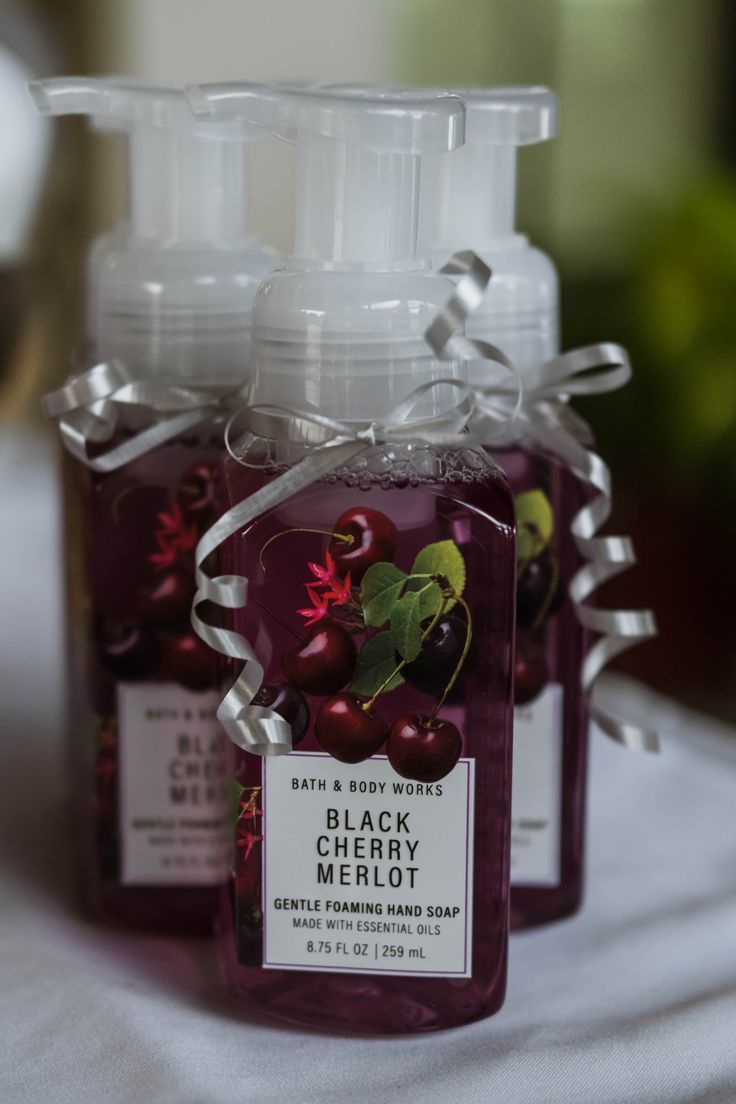 three bottles of liquid sitting on top of a table