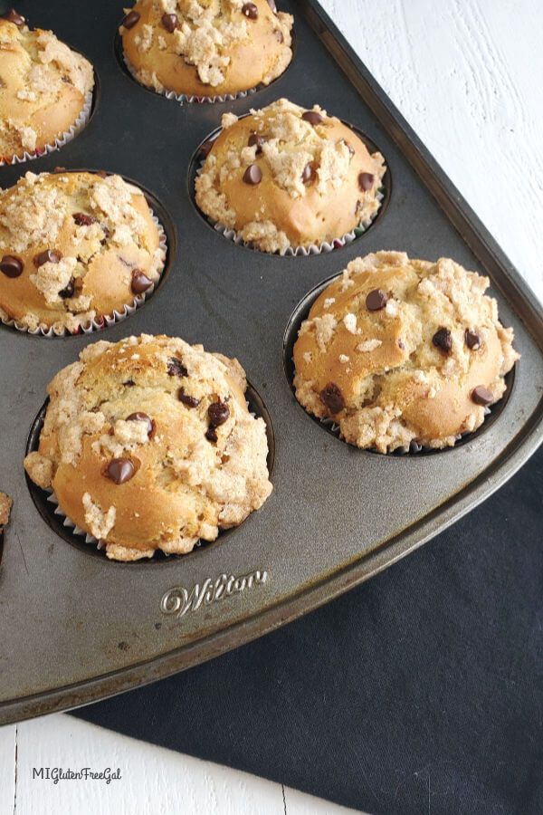 muffins in a baking pan with chocolate chip toppings on the top and bottom