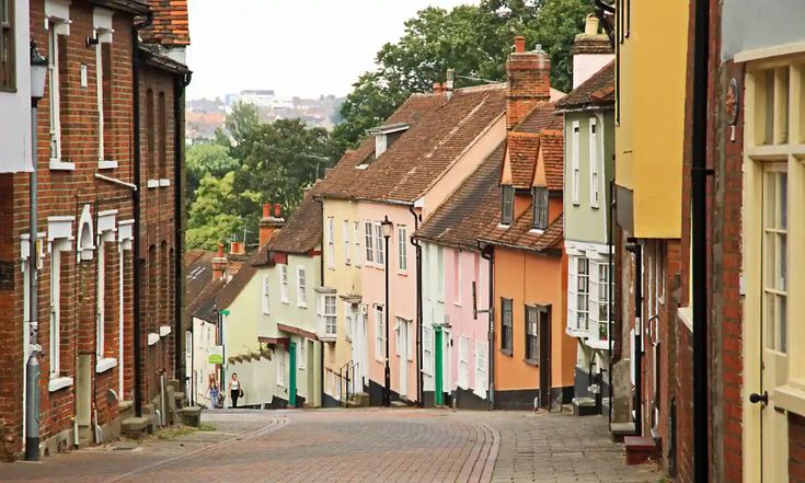 a cobblestone street lined with brick buildings