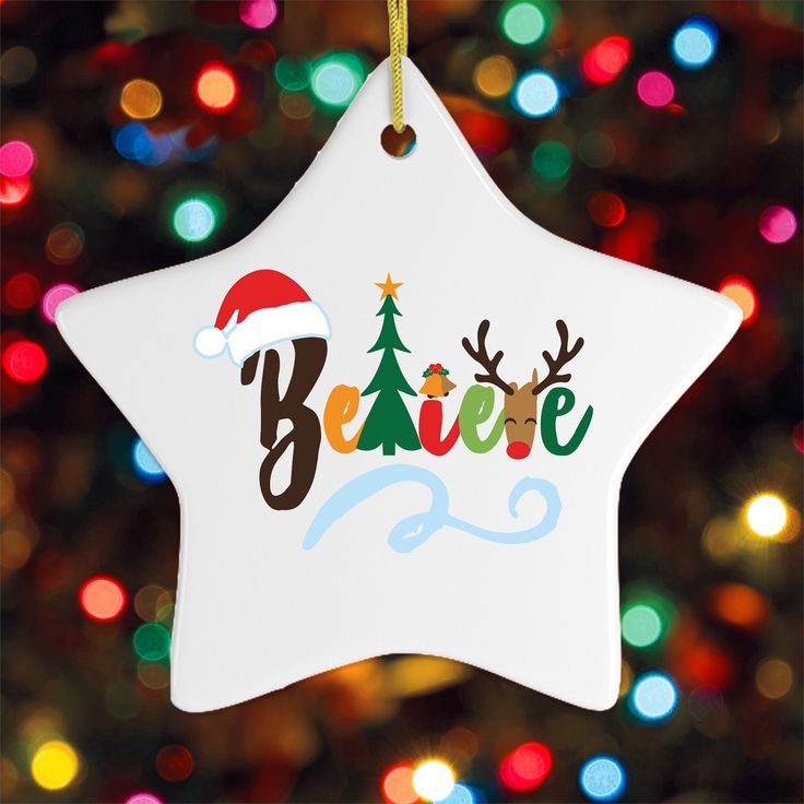 a white star ornament with the words believe and reindeers on it in front of a christmas tree