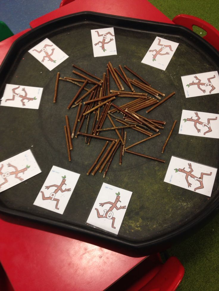 a bunch of nails sitting on top of a table next to some stickers and magnets