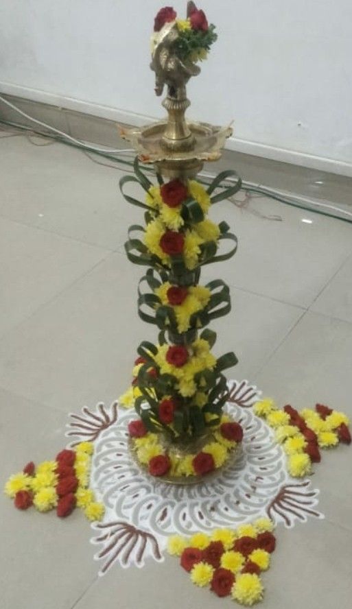 a decorative fountain with flowers on the floor