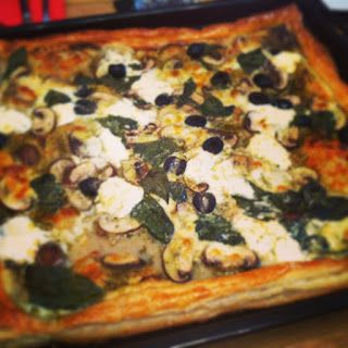 a square pizza sitting on top of a pan covered in toppings