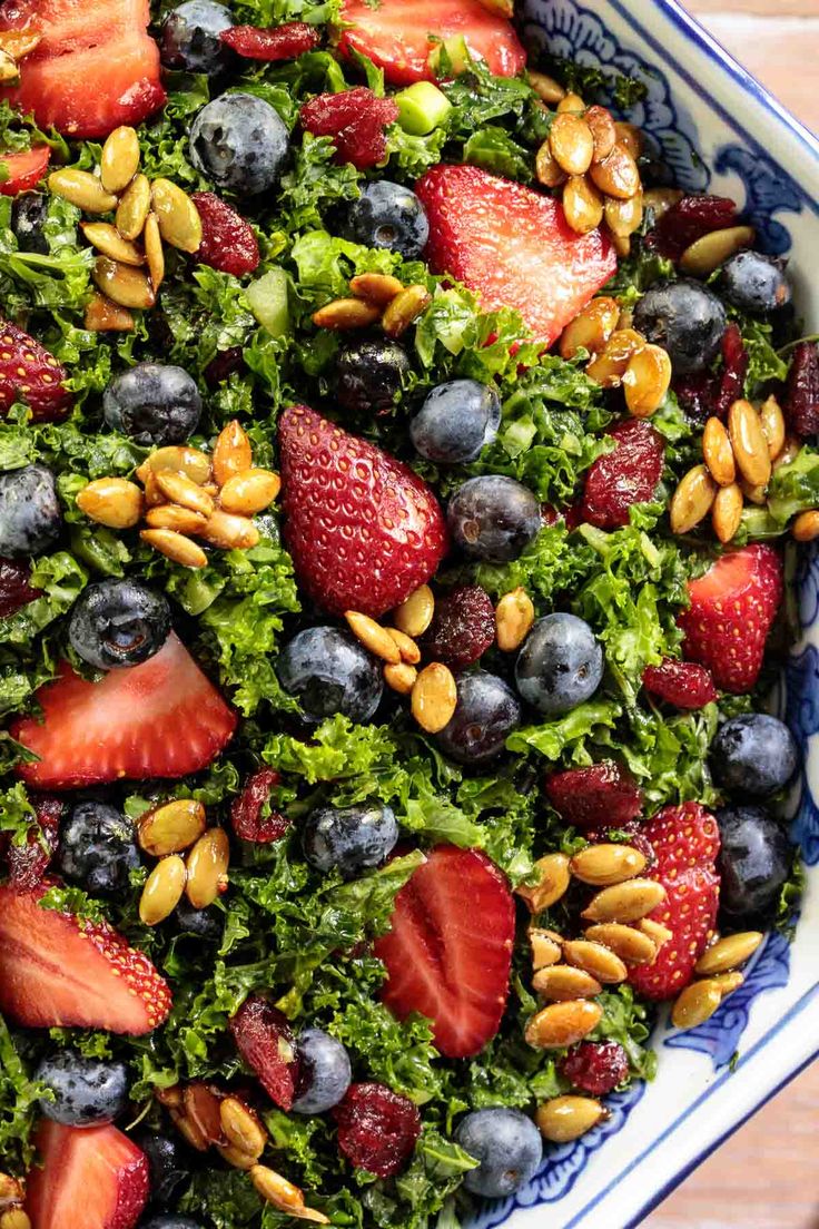 a salad with strawberries, blueberries and almonds