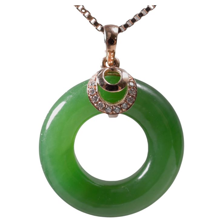 This ring-shaped hand-carved pendant features the finest green nephrite jade there is. This Chinese nephrite comes from the North-Western mountains of China and the nephrite features uncommonly pure apple-green coloring, together with extraordinary translucency and an evenness of tone, all of which together are rarely seen in nephrite. Bangles made of this same material sell for tens of thousands of dollars. It is so pure and so green it looks like glass. The impossibly luminous stone measures 1 Jade Gemstone Jewelry With Round Stones, Fine Jade Pendant Jewelry, Round Jade Gemstone Jewelry, Fine Green Jade Jewelry, Green Jade Jewelry With Round Stone, Jade Gemstone Round Jewelry, Carved Green Round Jewelry, Green Carved Round Jewelry, Fine Jewelry Jade Pendant