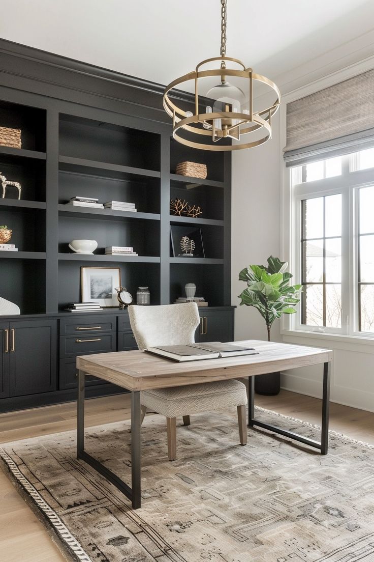 a living room with black built in bookcases and a rug on the floor