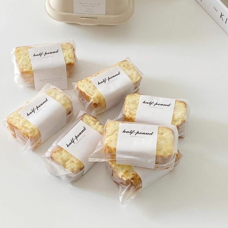 five pieces of bread wrapped in plastic sitting on a table