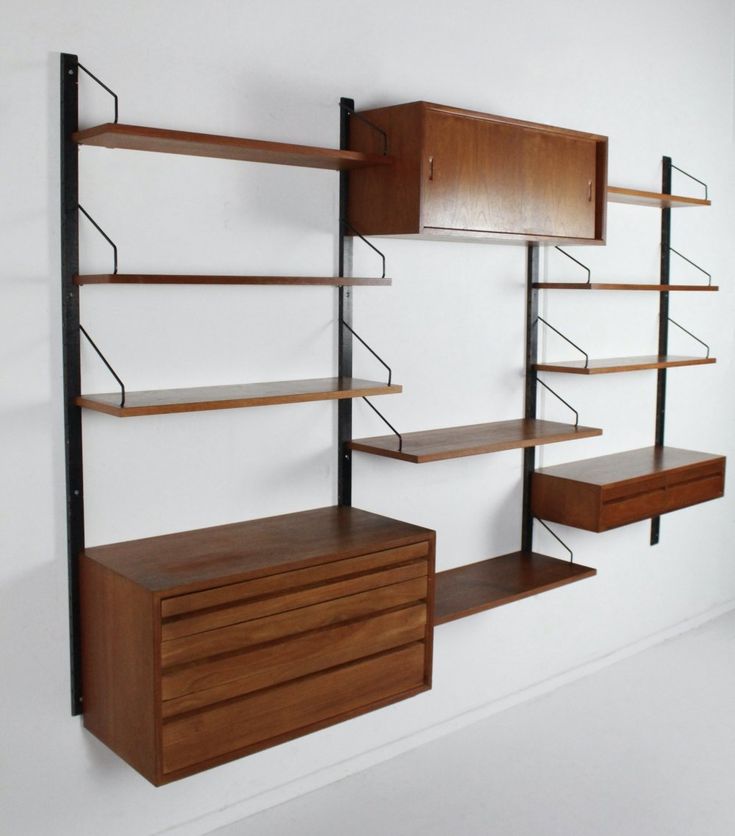 a wall mounted shelving unit with shelves and drawers