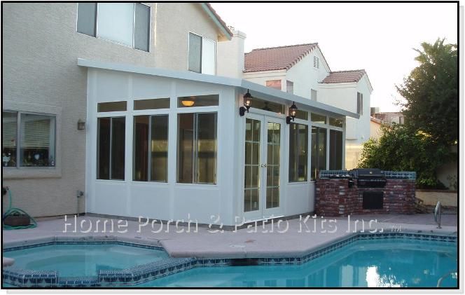 a house with a pool and hot tub next to it in front of the house