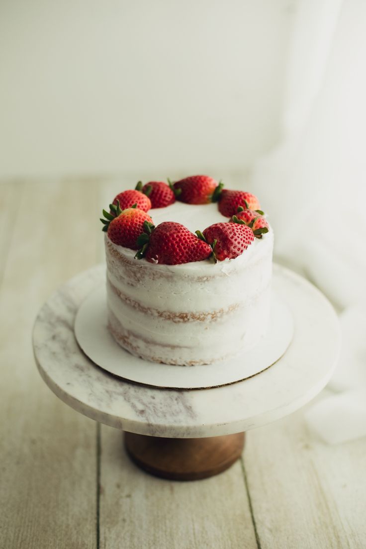 a white cake with strawberries on top