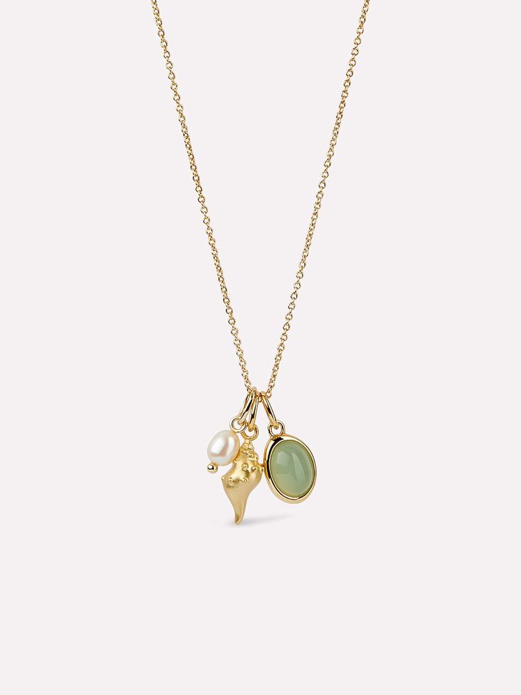 Dive into the beauty of this gold charm necklace designed in collaboration with influencer @OceansASMR. This piece is dipped in 14k gold and features three unique sea-inspired charms: a conch shell, a freshwater pearl, and a glass pendant. To channel your inner mermaid, pair this gold charm necklace with our Frida gold huggie hoop earrings. • Dipped in 14k gold • Designed in collaboration with influencer @OceansASMR • Freshwater pearl and glass charms Dainty Charm Necklace, Surf Jewelry, Jewellery Art, Jewelry Accessories Ideas, Dope Jewelry, Gold Charm Necklace, Classy Jewelry, Jewelry Essentials, Stacked Jewelry