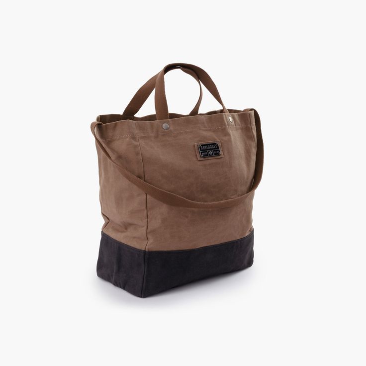 a brown and black tote bag on a white background