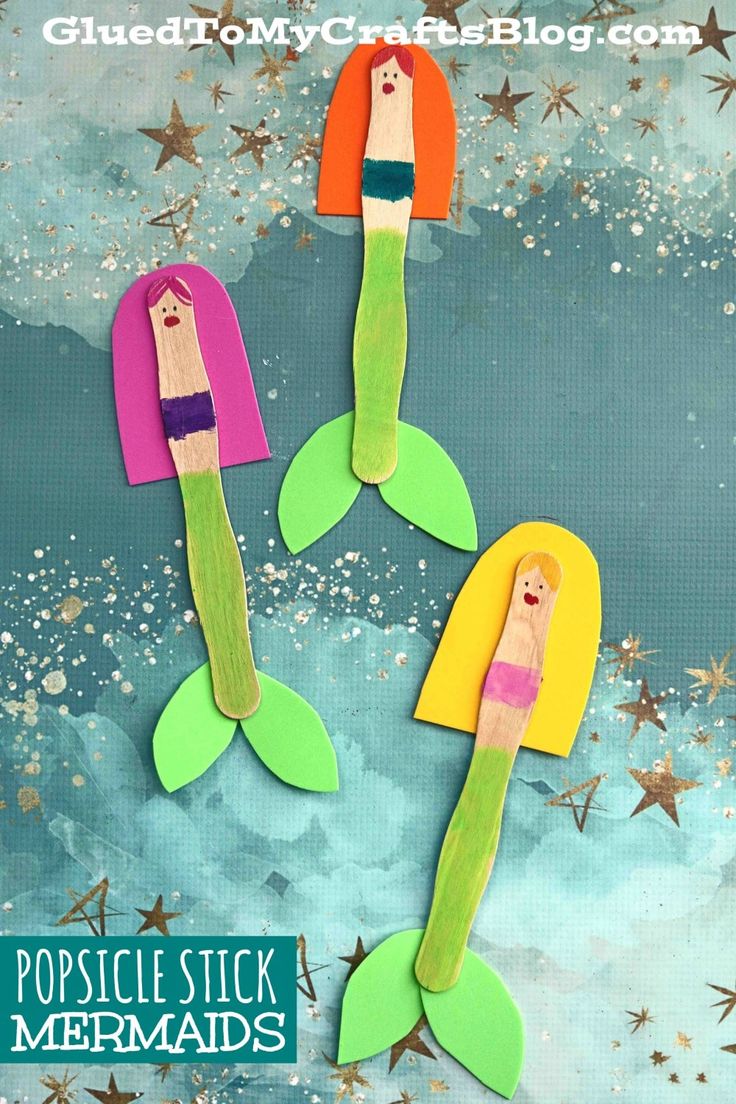 three mermaids made out of popsicle stick are sitting in the water with stars around them