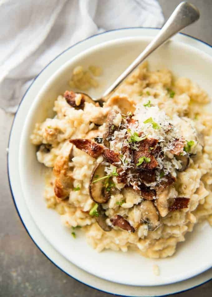 a white bowl filled with rice and mushrooms