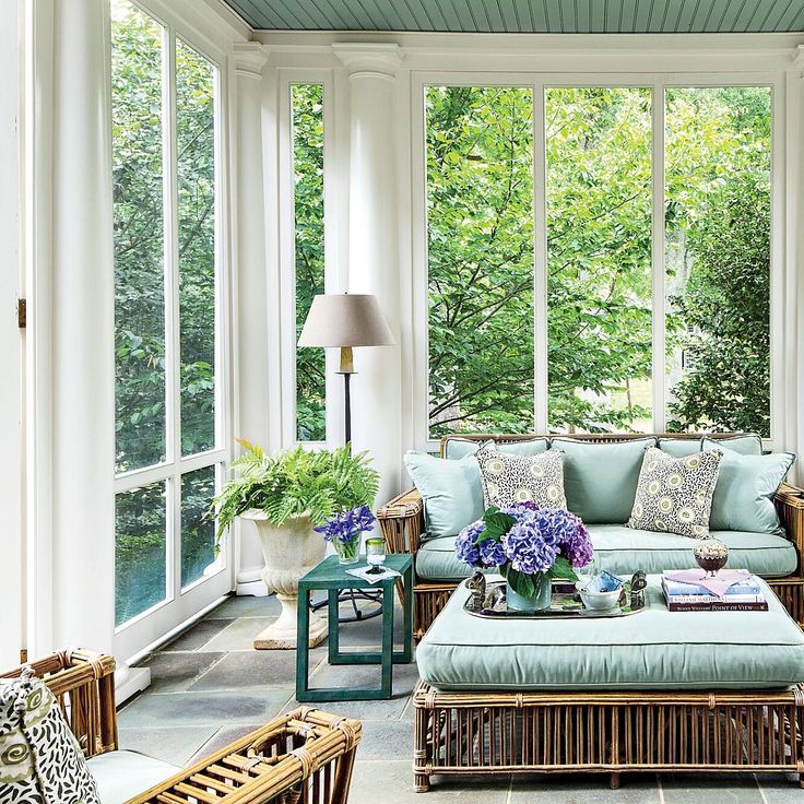 a living room filled with furniture and lots of windows