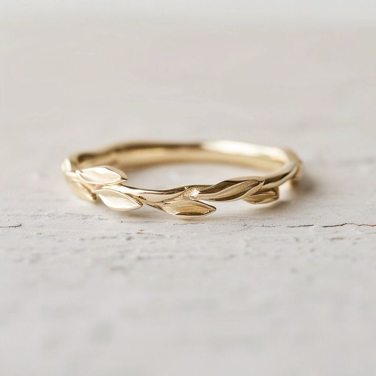 a gold ring with leaves on it