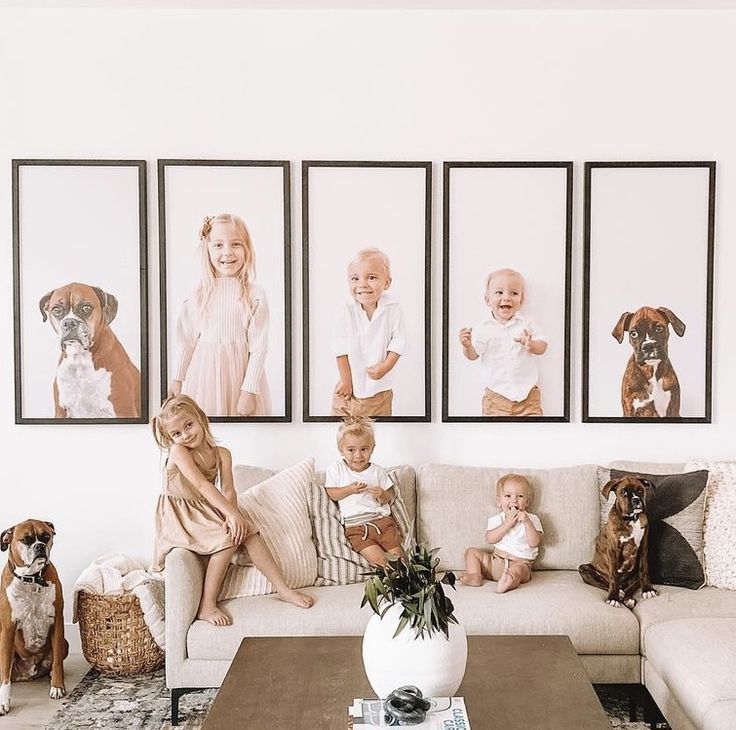 a living room filled with furniture and pictures hanging on the wall above it's coffee table