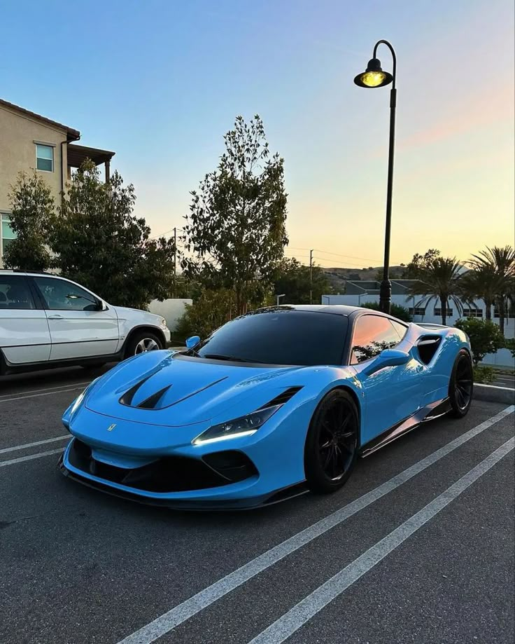 a blue sports car parked in a parking lot