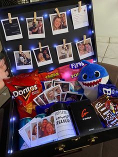 an open suitcase filled with photos and pictures