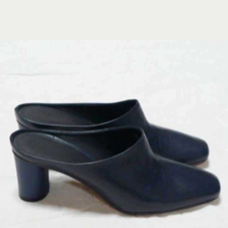 Gray Matters Square Toe Soft Leather Mule Pump. Cylinder Shaped Matte Lacquer Coated 2.3" Heel. Soft Leather Insole. Suede Sole. We Recommend Half A Size Larger For Women With A High Foot Arch. European Sizing. Best Fits A Size 10. New Never Worn, Cobbler Added Rubber Bottom. Includes Box And Dust Bag. Color Is Deep Navy. Navy Color. Designed In Nyc. Made In Italy. Modern Blue Heels For Work, Modern Blue Slip-on Mules, Evening Blue Mules With Padded Heel, Blue Evening Mules With Padded Heel, Blue Pointed Toe Mules For Evening, Formal Blue Mules With Padded Heel, Blue Leather Mules For Evening, Blue Pointed Toe Mules With Sculpted Heel, Blue Mules With Sculpted Heel And Pointed Toe