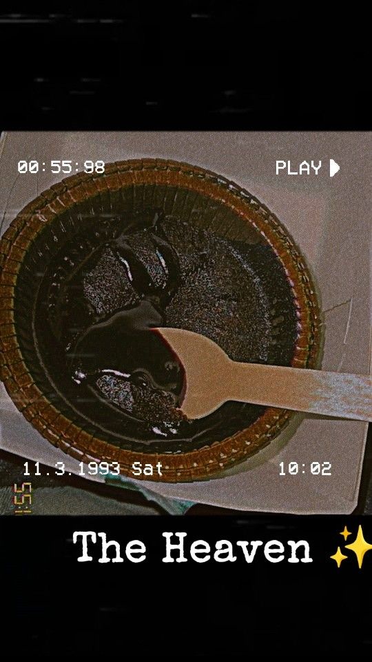 there is a spoon in the bottom of a bowl that has chocolate sauce on it