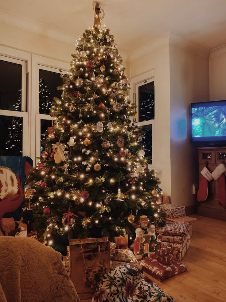 a christmas tree is lit up in the living room