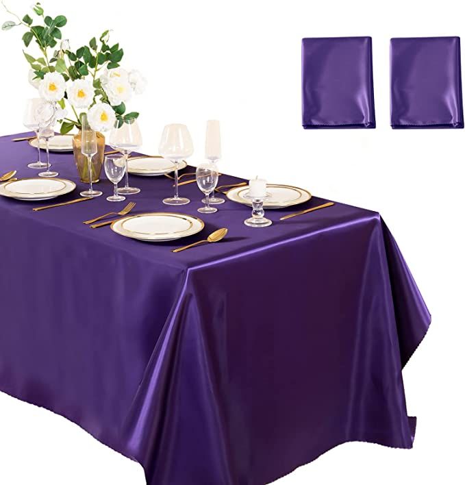 a purple table cloth with place settings on it