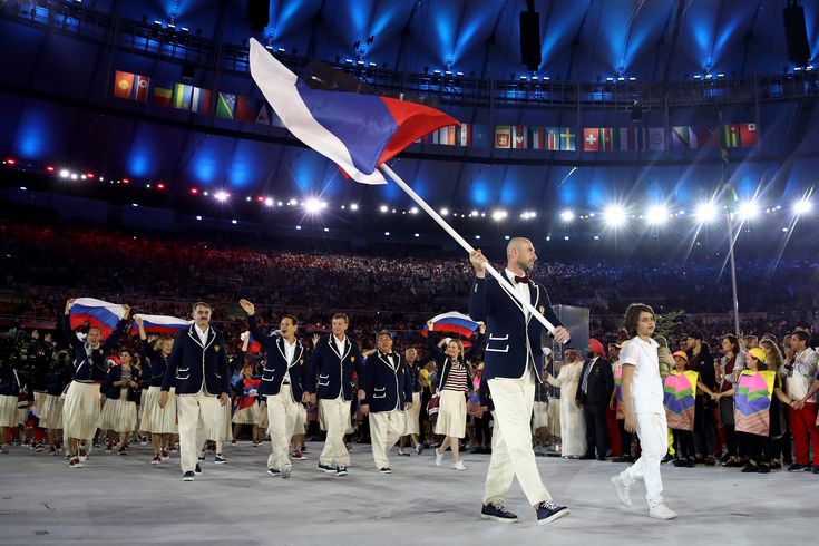 a man holding a flag in front of a crowd