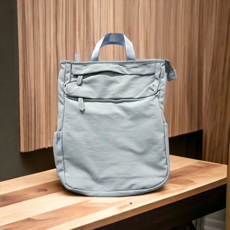 a blue backpack sitting on top of a wooden table