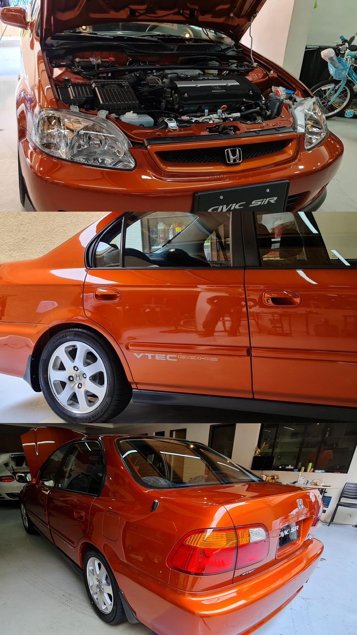 an orange car with its hood open in a garage