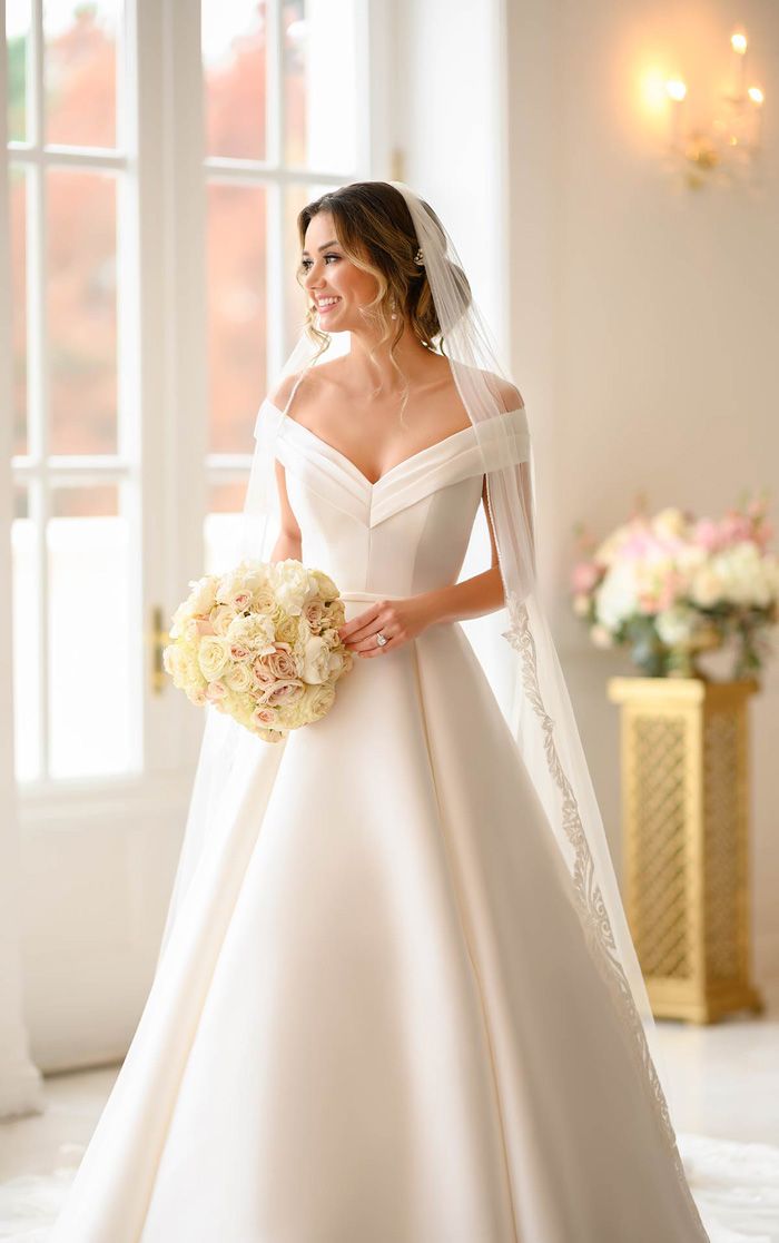 a woman in a wedding dress holding a bouquet