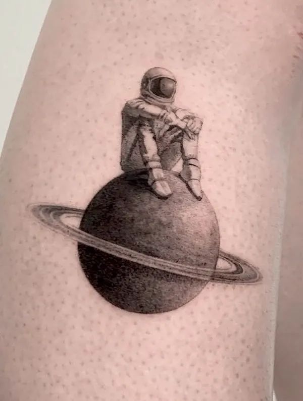 an astronaut sitting on top of a ball with the planet in front of him and his arm behind him