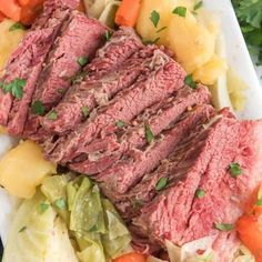 sliced meat and vegetables on a plate with parsley garnished in the center