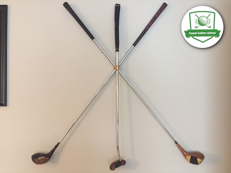 four golf clubs are hanging on the wall