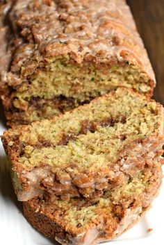 a loaf of banana nut bread on top of a white plate with one slice cut off